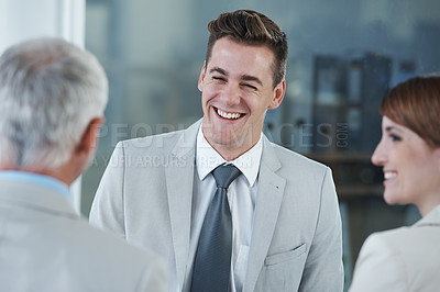 Buy stock photo Smile, interview and hr with candidate in office for business meeting, discussion or recruitment. Happy, hiring and man talking to professional human resources managers in workplace boardroom.
