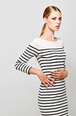Buy stock photo Portrait, fashion dress and serious woman in studio isolated on a white background mockup. Confidence, style and young female model from Switzerland in trendy clothes, outfit stripes and aesthetic.