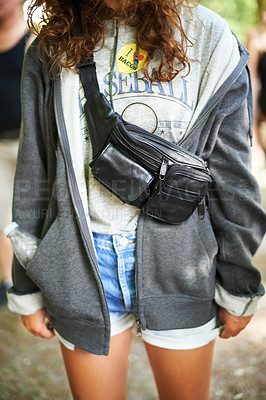 Buy stock photo Cropped image of a young woman wearing a moonbag around her shoulders