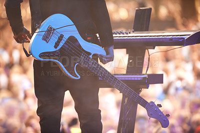Buy stock photo A performer standing with his guitar in front of a keyboard facing the audience