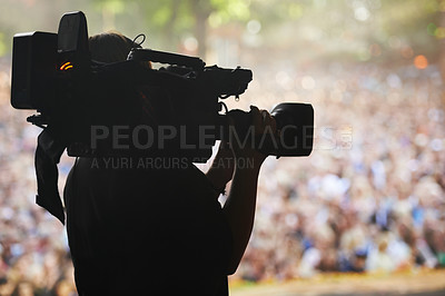 Buy stock photo A silhouette of a cameraman filming an event