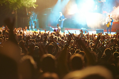 Buy stock photo Shot of fans enjoying an outdoor music festival