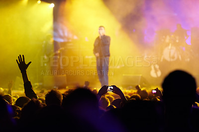 Buy stock photo Concert, audience and hands in crowd with band for music festival, night club and cheering with light. Disco, artist and people with sign, gesture and performance at rock event with entertainment 