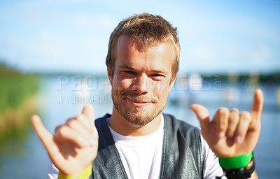 Buy stock photo Head and shoulders shot of a young man having a good time at an outdoor festival