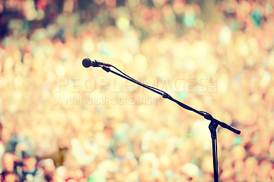 Buy stock photo A microphone on a stand on an empty stage with the audience in the background