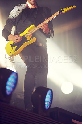 Buy stock photo Man, stage and guitar for performance at concert, music festival or live event in Amsterdam. Male artist, electric instrument and playing on stage for crowd, people or audience with enjoyment