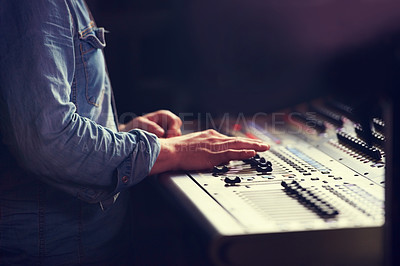 Buy stock photo Closeup, hands and sound engineer with a mixing desk, music and artist recording with equipment. Fingers, creative and musician with automatic equalizer, professional and buttons for songs and sounds