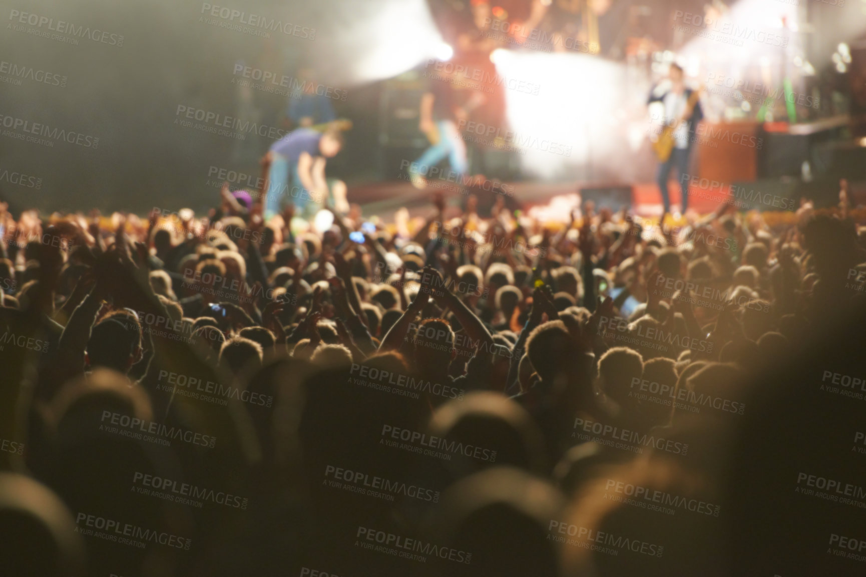 Buy stock photo Crowd, live concert and stage with dancing audience as music festival for entertainment, performance or carnival. People, hands and fans of musicians with lighting for rock event, rave or vacation