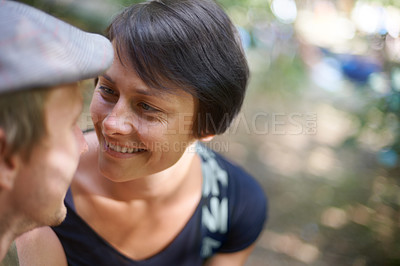 Buy stock photo Couple, happy and together with smile outdoors for love, bonding and collaboration in nature. Man, woman and flat cap with appreciation for relationship, marriage or partnership from high angle