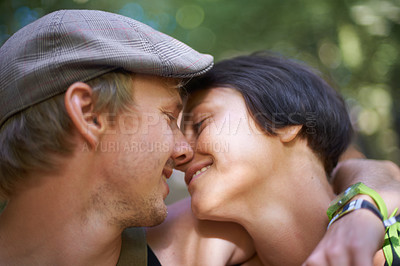 Buy stock photo Couple, closeup and embrace outdoors for date with wristband for festival, concert or adventure together. Man, woman and smile with flat cap for summer in nature, forest or woods with happiness
