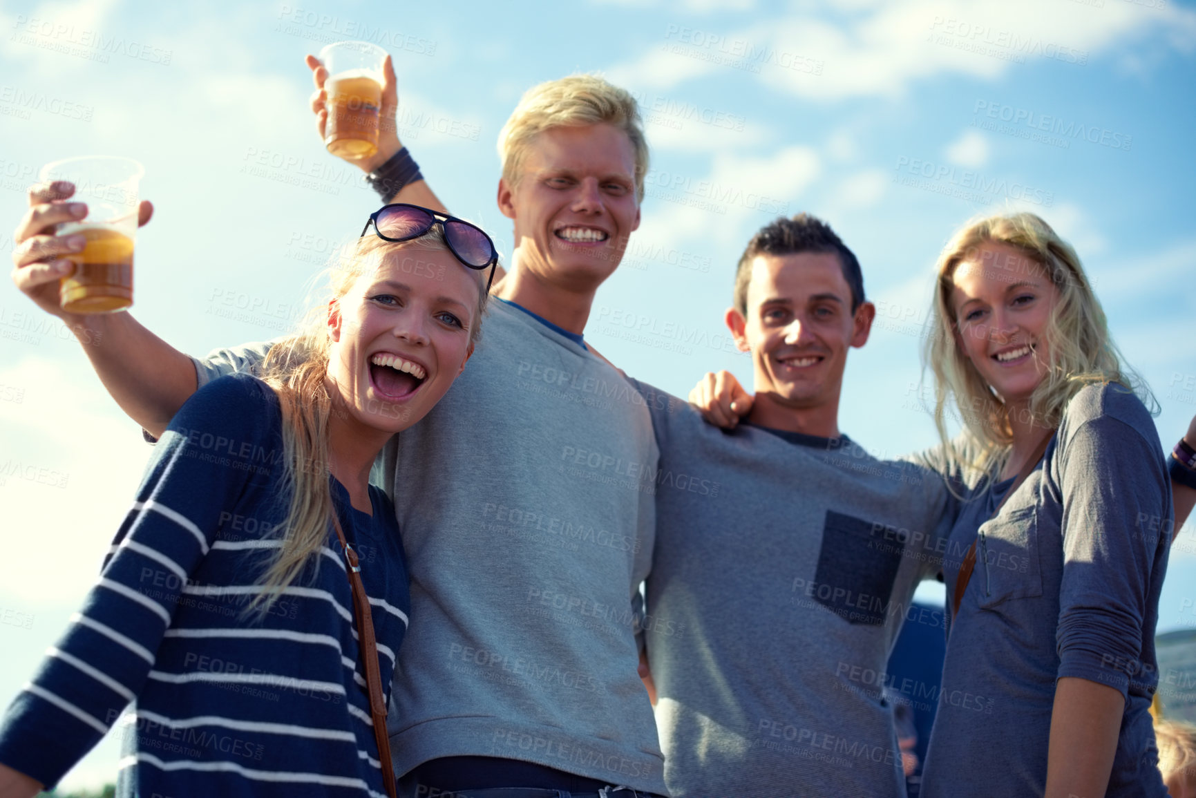 Buy stock photo Portrait, beer and group of friends party, celebration or happy adventure together on low angle. Smile, drinks and blue sky, men and women on vacation to relax with bonding, alcohol and holiday event