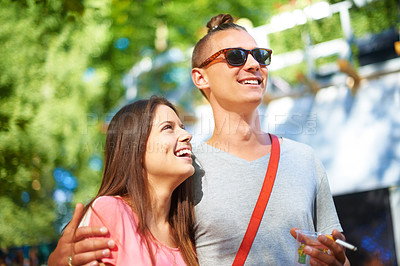 Buy stock photo Hug, smile and couple at music festival outdoor, event and celebration on valentines day together in summer. Cigarette, man and happy woman at party, carnival and laugh in nature with drink at park