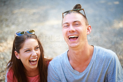 Buy stock photo Two young people smiling happily as they sit outside