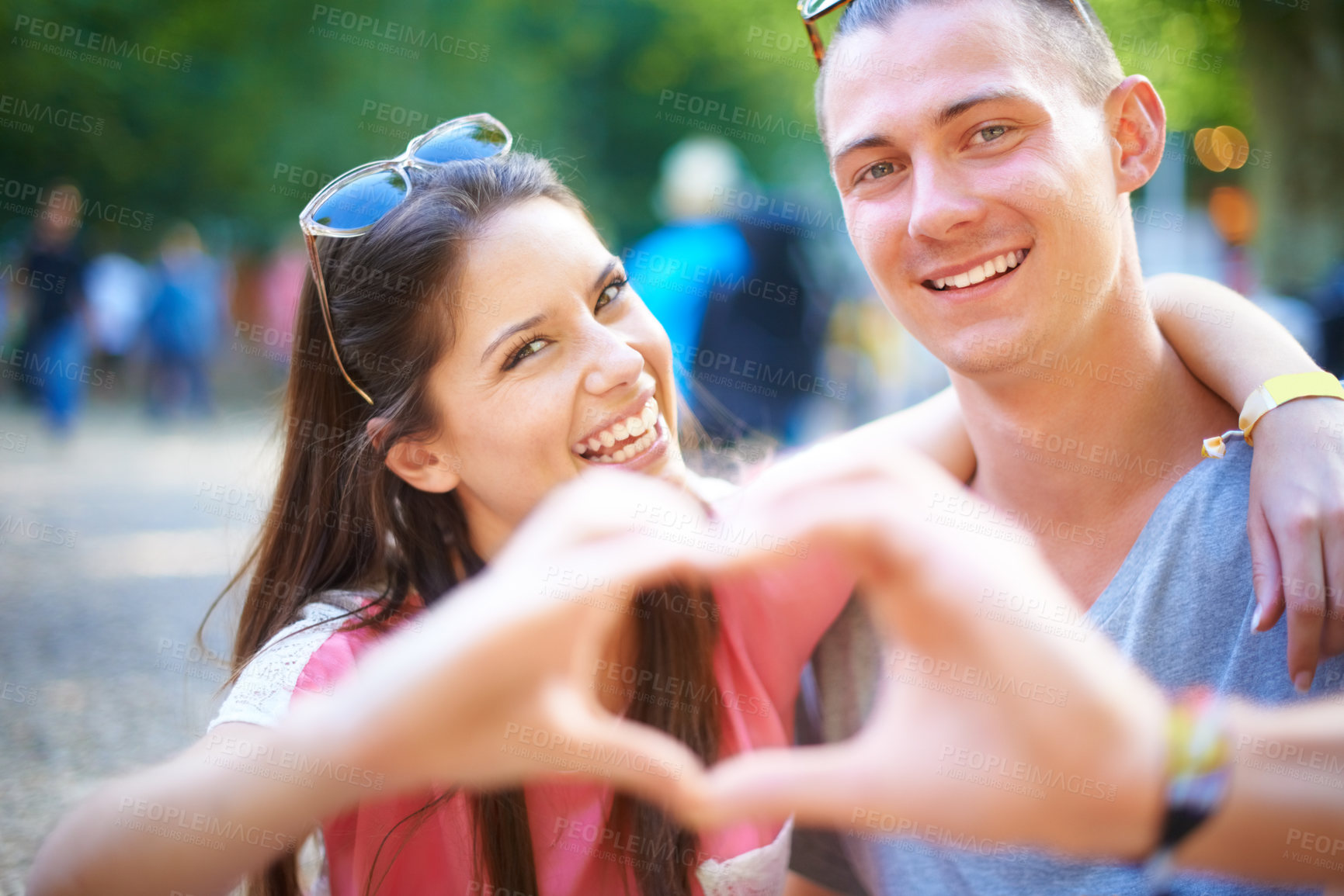 Buy stock photo A young couple making a heart sign with their hands