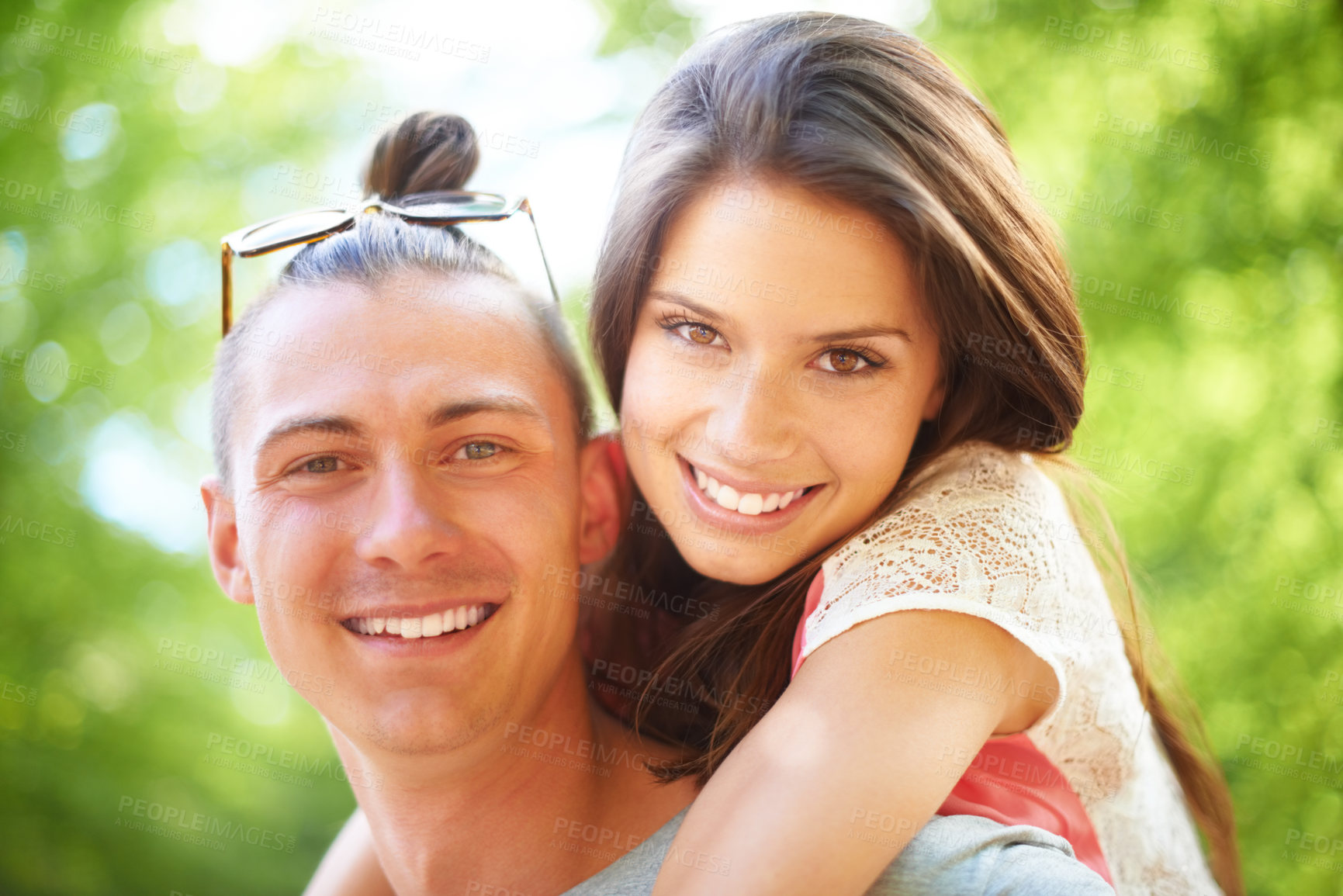 Buy stock photo A trendy young man giving his girlfriend a piggyback ride