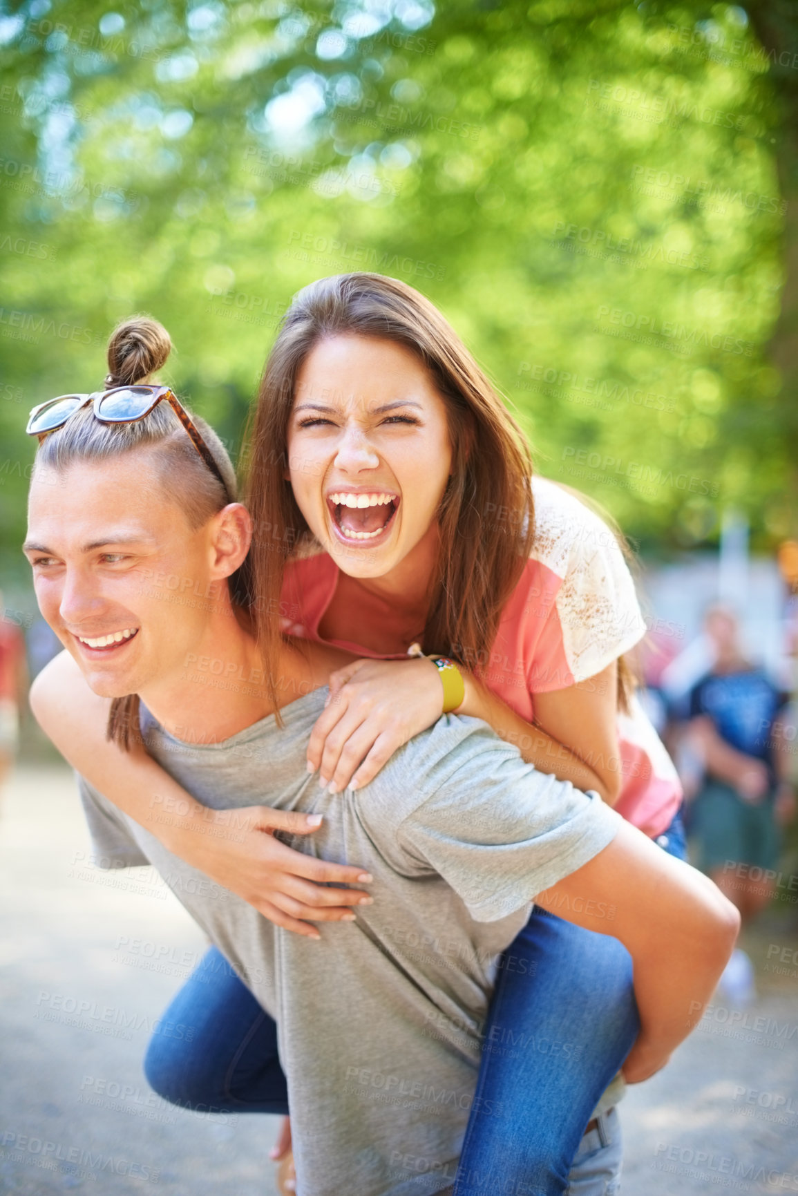 Buy stock photo A trendy young man giving his girlfriend a piggyback ride