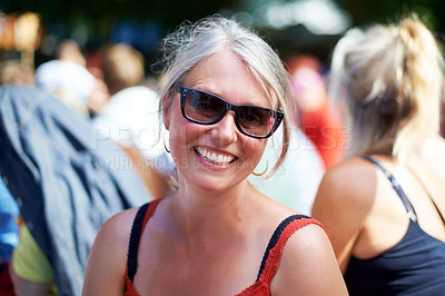 Buy stock photo Senior, woman and portrait with sunglasses outdoor in crowd, happy and festival on vacation for fun. Person, lifestyle and concert on holiday for music, event and smiling with people or audience