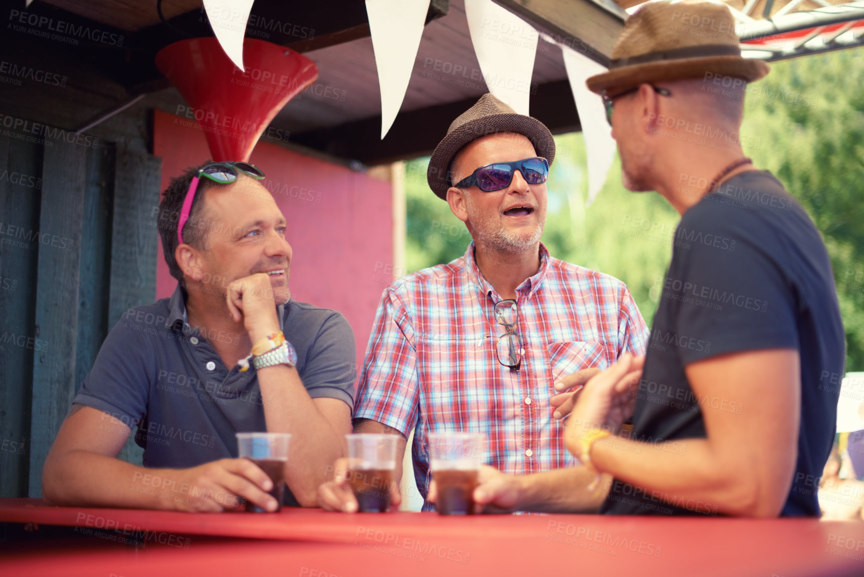 Buy stock photo Men, friends and drinking beer at music festival, talking and bonding together at social gathering. People, group and alcohol at party, carnival and concert for celebration event in summer outdoor