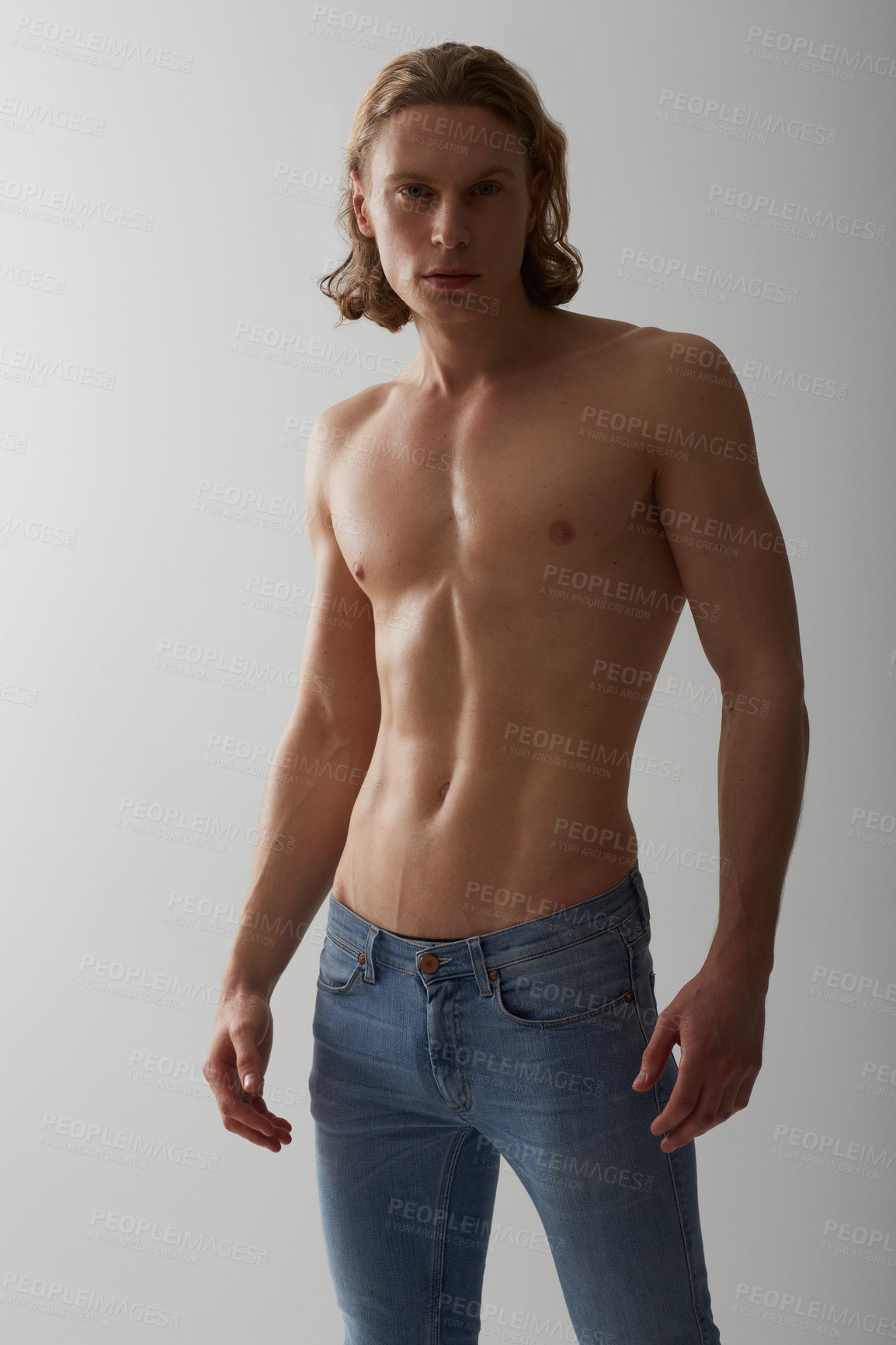Buy stock photo Shirtless, model and portrait of man in jeans on studio, white background and mockup with fashion. Male, beauty and topless person with abs in denim pants, cool style and confidence in backdrop