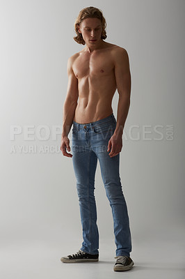 Buy stock photo Shirtless, model and man in jeans on studio, white background and mockup with fashion. Male, beauty and handsome topless person with abs in denim pants, cool style and confidence in backdrop
