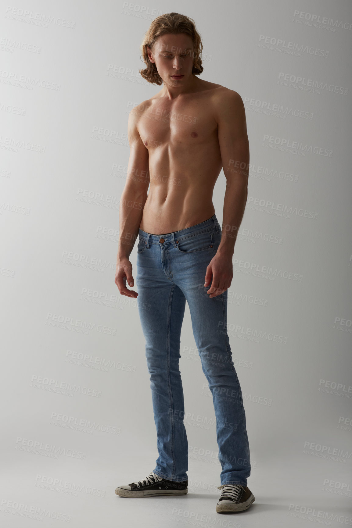 Buy stock photo Shirtless, model and man in jeans on studio, white background and mockup with fashion. Male, beauty and handsome topless person with abs in denim pants, cool style and confidence in backdrop