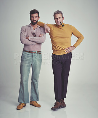 Buy stock photo Studio shot of two men standing together while wearing retro 70s wear