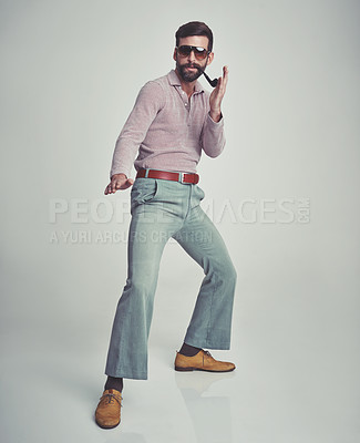 Buy stock photo 70s, fashion and portrait of man with retro or vintage aesthetic in gray background of studio. Smoking, pipe and person dance with confidence in funky sunglasses and unique style from past or history