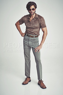 Buy stock photo A handsome man in retro 70s clothing striking a pose in the studio