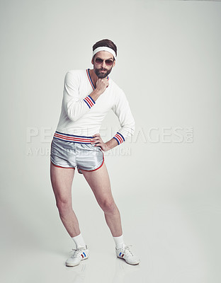 Buy stock photo A young man in the studio wearing retro sportswear and shades