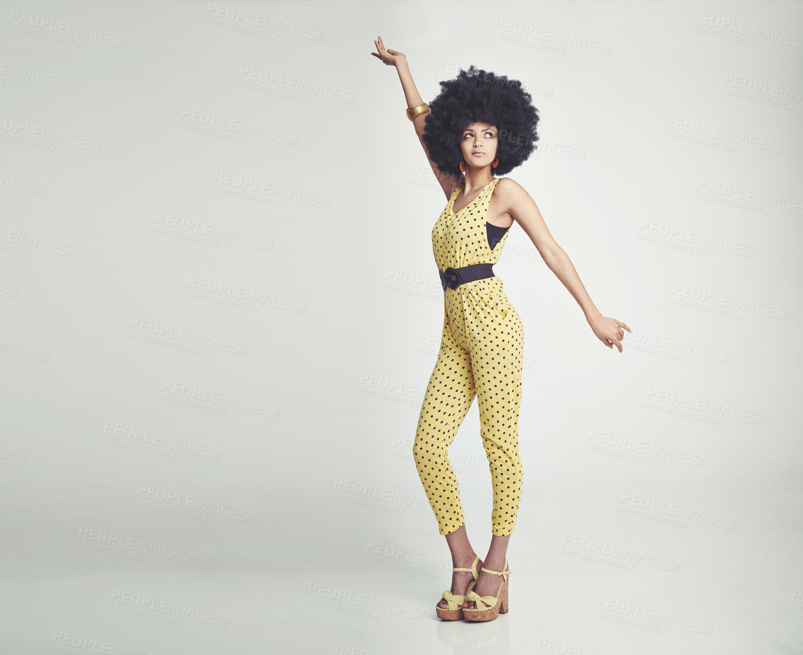 Buy stock photo Black woman, jumpsuit and fashion dancing in studio for vintage look, gen x and retro style for old school. African girl, afro and unique with white background for pose, isolated and confident.
