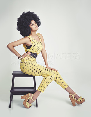 Buy stock photo Black woman, portrait and retro in studio, vintage and hand on waist, unique and dots in clothes. Fashion, hippy and person with hair, model and strong African lady, yellow and girl sitting in chair