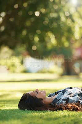 Buy stock photo Happy, park and woman on grass to relax for rest in garden, nature or field with smile or peace. Smile, freedom and female person on break with smile on face for summer vacation, holiday or wellness