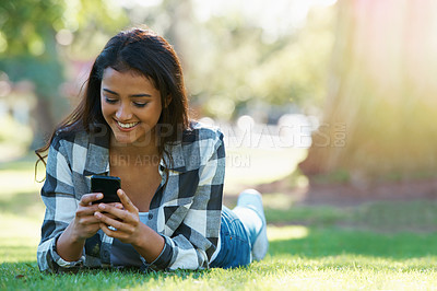 Buy stock photo Grass, phone or happy woman in park for social media to chat on internet post or website notification. Nature, smile or female person on mobile app for texting, networking or typing online to relax