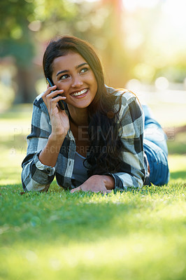 Buy stock photo Phone call, relax and Indian woman in a park, student and happiness with conversation and contact. Person, outdoor and girl with a smartphone or summer with weekend break or sunshine with digital app