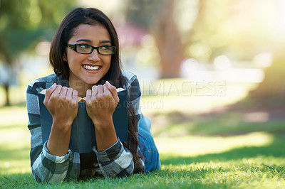 Buy stock photo Happy woman, student and relax with book in nature for literature, studying or story on green grass. Young nerd, geek or female person with smile and glasses for chapter, learning or outdoor reading