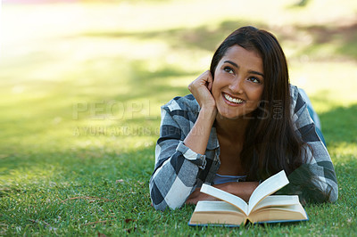 Buy stock photo Woman, thinking and reading book on grass, literature and smiling for fiction or fantasy story. Female person, nature and relaxing on lawn for knowledge, daydreaming and student studying in garden