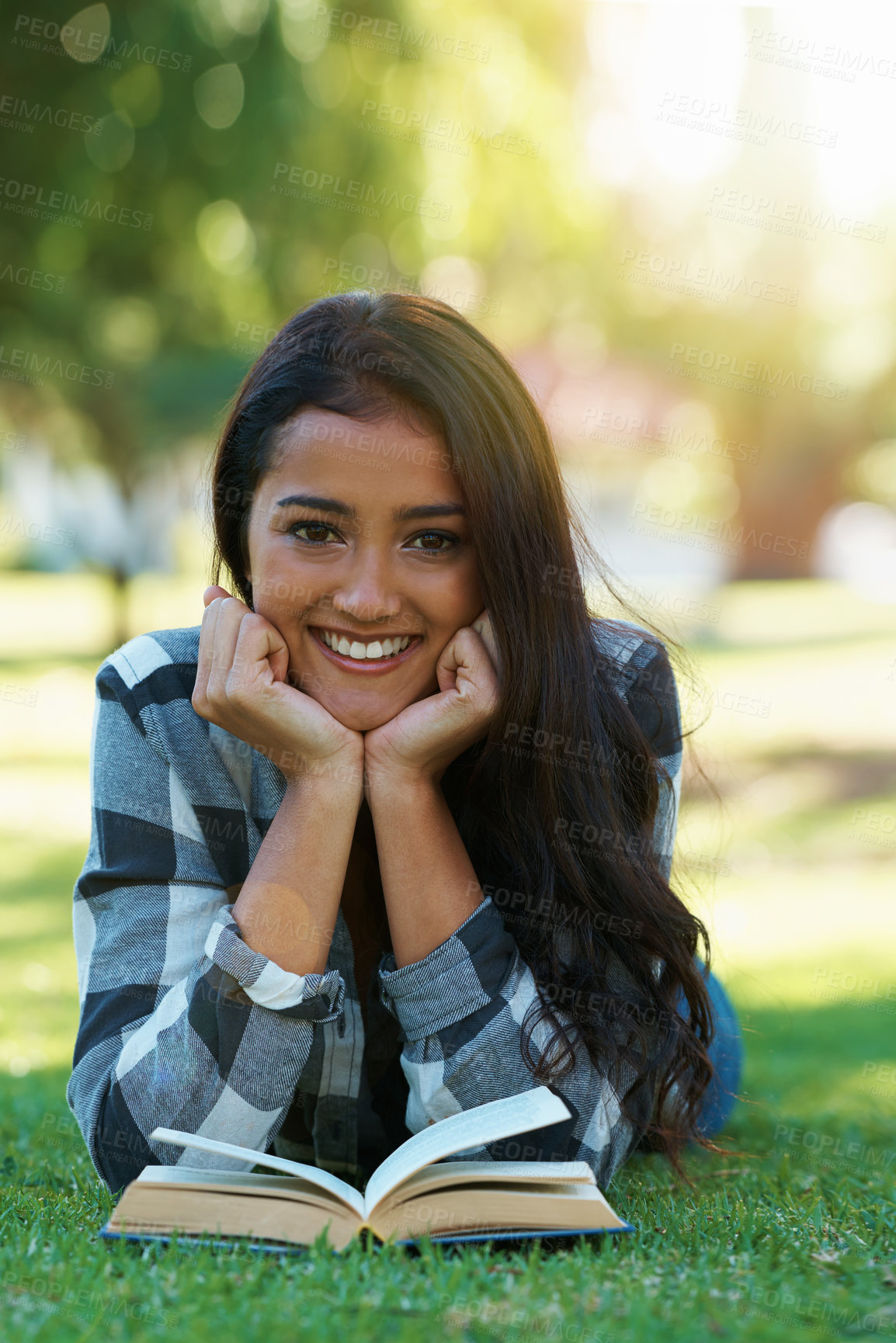 Buy stock photo Woman, portrait and reading book on grass, literature and smiling for fiction or fantasy story. Female person, nature and relaxing on lawn for knowledge, information and student studying in garden