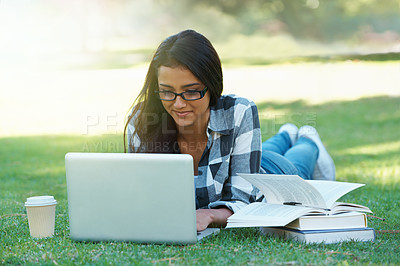 Buy stock photo Young woman in a park with her laptop
