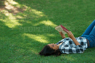 Buy stock photo Woman, knowledge and reading book on grass, literature and smiling for fiction or fantasy story. Female person, nature and relaxing on lawn for education, information and student studying in garden