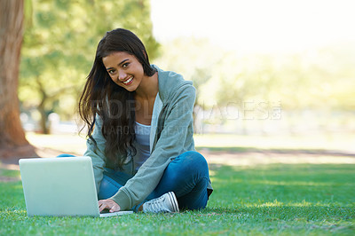 Buy stock photo College, woman and typing on laptop in park with research, project or learning outdoor on campus. University, student and girl studying online with ebook, education and computer on lawn in garden