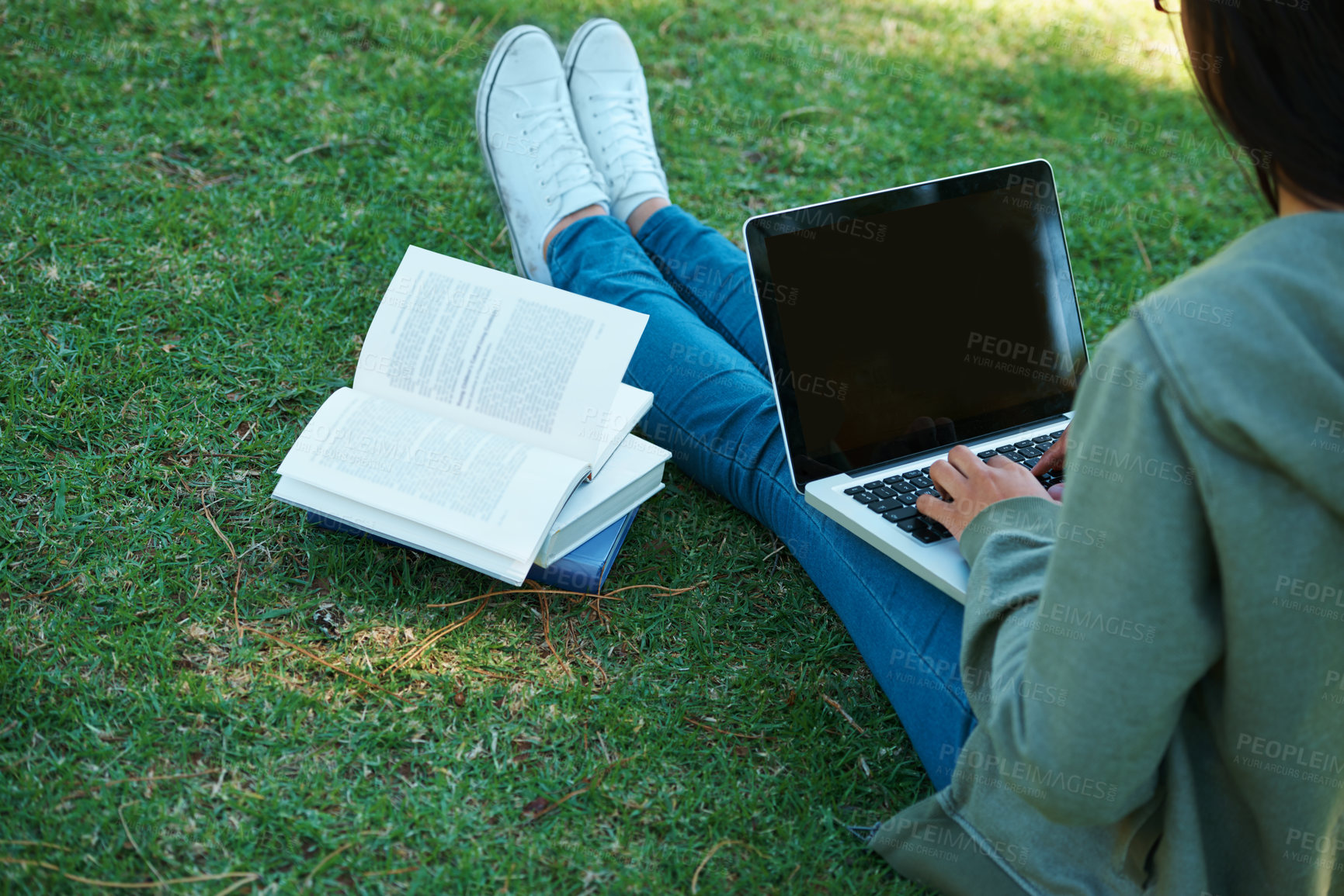 Buy stock photo Study, book and person with laptop in park on campus for research, report and education at college. University, student and girl typing on computer with analysis of philosophy or reading on grass