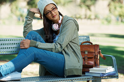 Buy stock photo Thinking, relax and student in park with books for studying, learning and reading outdoors. Education, happy and person with bag, textbooks and headphones on bench for university, campus or college