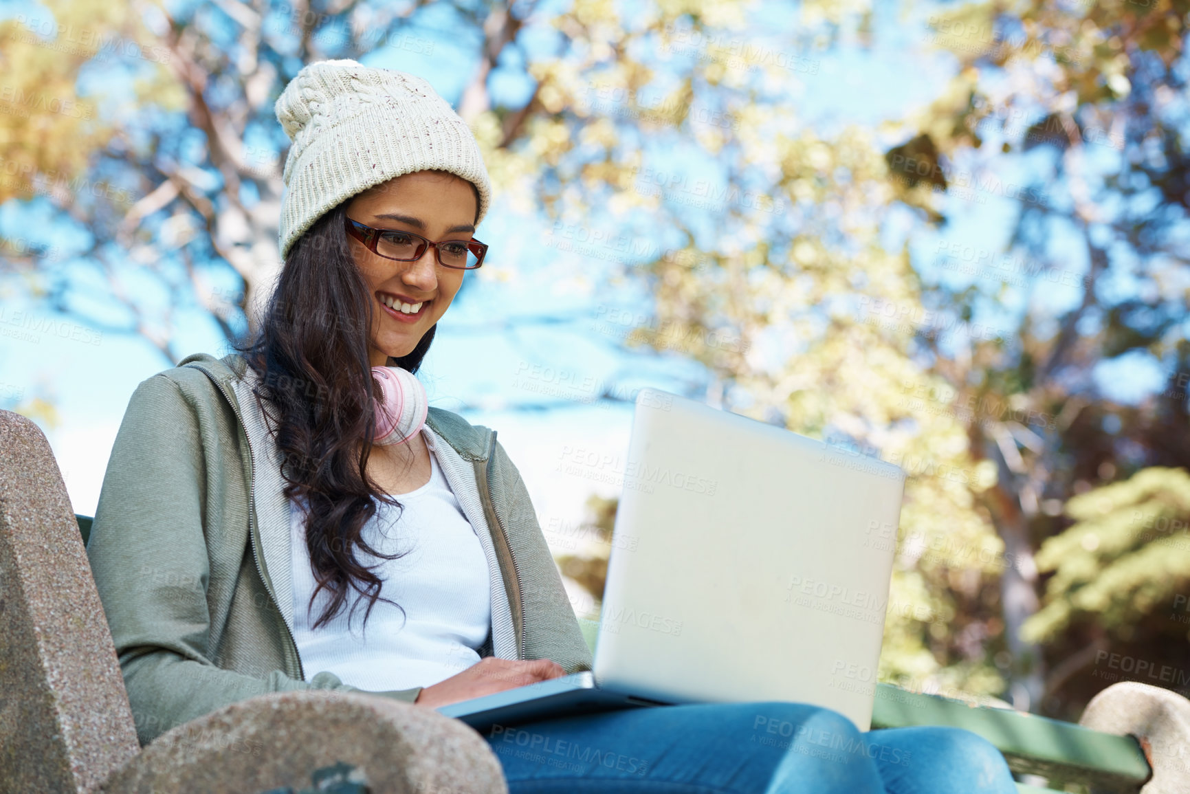 Buy stock photo Woman, typing and college student on laptop in park with research, project or learning on campus. University, education and girl reading online with ebook on computer and study in garden with nature