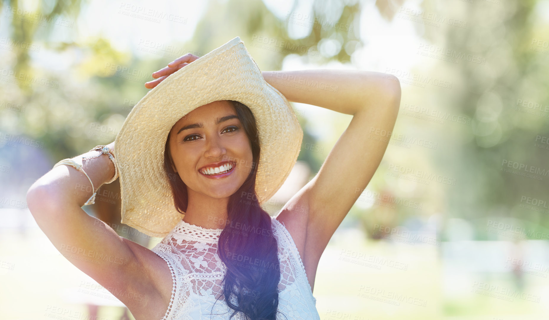 Buy stock photo Woman, portrait and hat for relaxing in park or garden, smiling and joyful on summer holiday. Female person, peace and enjoy vacation in countryside, outdoors and calm on weekend adventure in nature