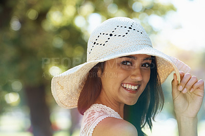 Buy stock photo Woman, portrait and travel to park or garden, smiling and joyful on summer holiday in nature. Female person, peace and enjoy vacation in countryside, outdoors and calm or hat on weekend adventure