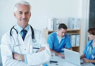 Buy stock photo Smile, crossed arms and portrait of doctor in meeting with nurses for medical research in hospital. Happy, confident and senior male surgeon in clinic office with healthcare workers for discussion.