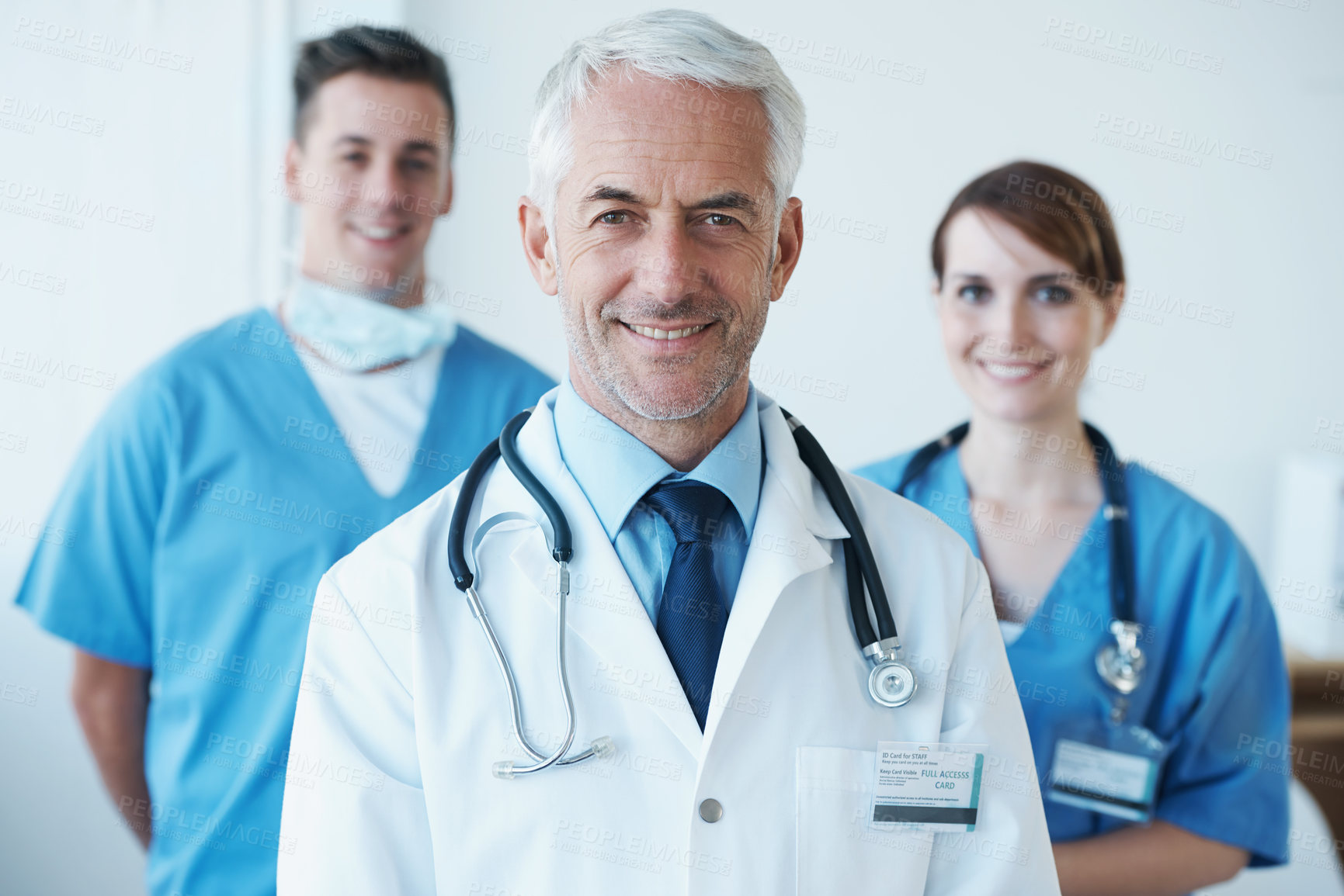 Buy stock photo A group of healthcare workers standing and smiling at the camera