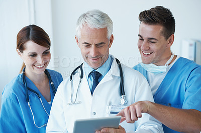 Buy stock photo Tablet, research and doctor with nurses in hospital for medical diagnosis or treatment discussion. Team, digital technology and senior surgeon talking to healthcare workers for surgery in clinic.