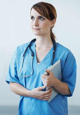 Buy stock photo Nurse, woman and thinking with tablet in studio for healthcare, wellness and medic for medicare. Female medical physician, digital touchscreen tech and professional nursing expert for telehealth