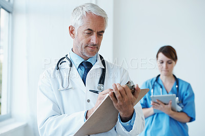 Buy stock photo Checklist, research or mature doctor writing medical notes, feedback review or schedule in hospital. Clipboard, healthcare paperwork update or man in clinic working on a science report or medicine